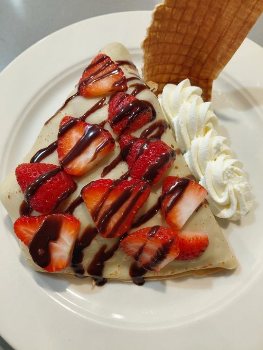 Strawberry and house-made whipped cream crepe with chocolate sauce at Crepes & Treats St. Louis