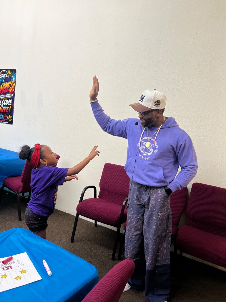 Leader giving high-five to child at IGNITE VBS