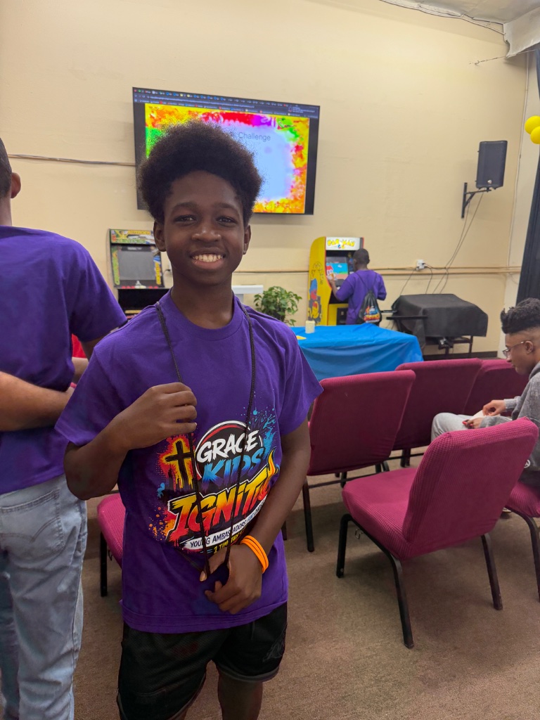 Teen smiling in IGNITE VBS shirt