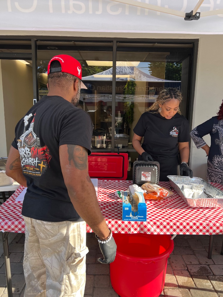 BBQ Church outdoor serving setup with team members
