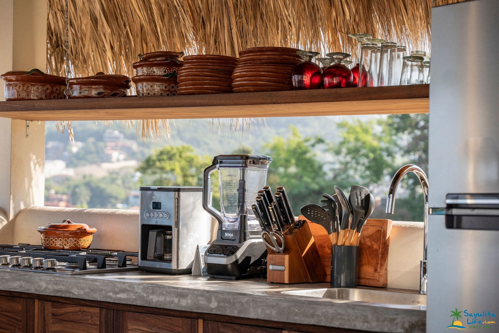 Rustic kitchen counter with pottery and cookware