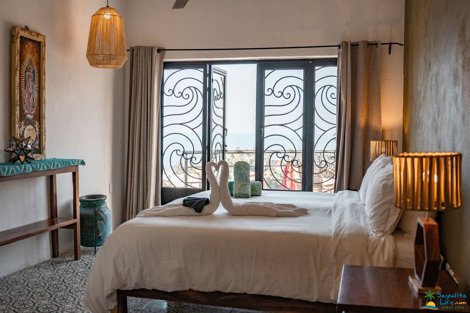 Bedroom with heart towels and balcony doors