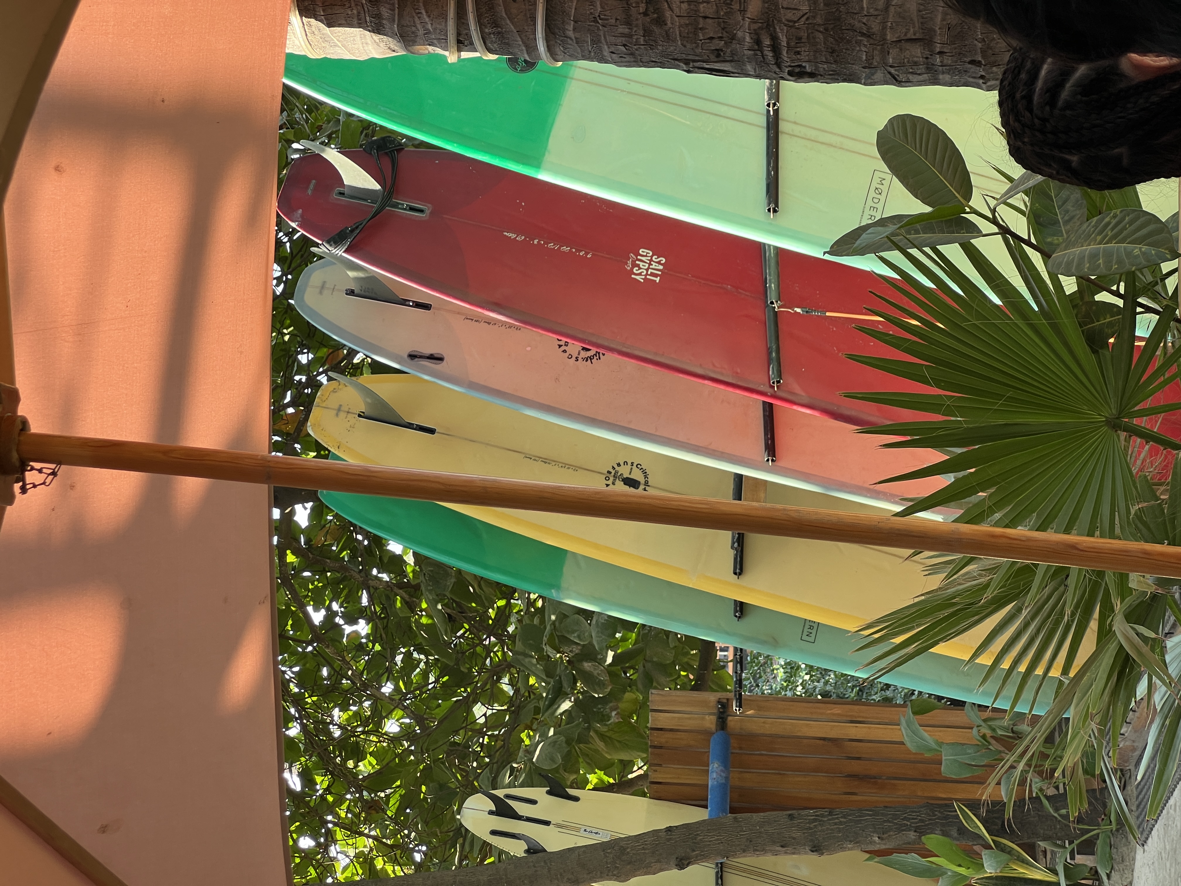 Rack of longboards under the Sayulita sun
