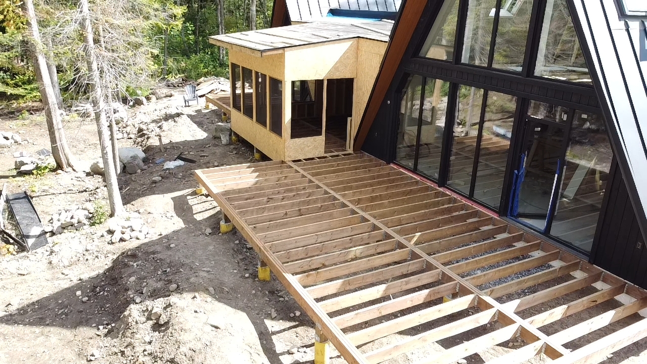 Deck framing in progress on an A-frame home