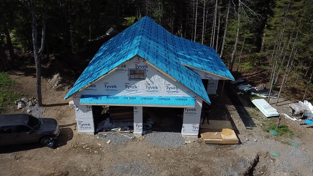 Drone view of a newly framed building wrapped and roofed