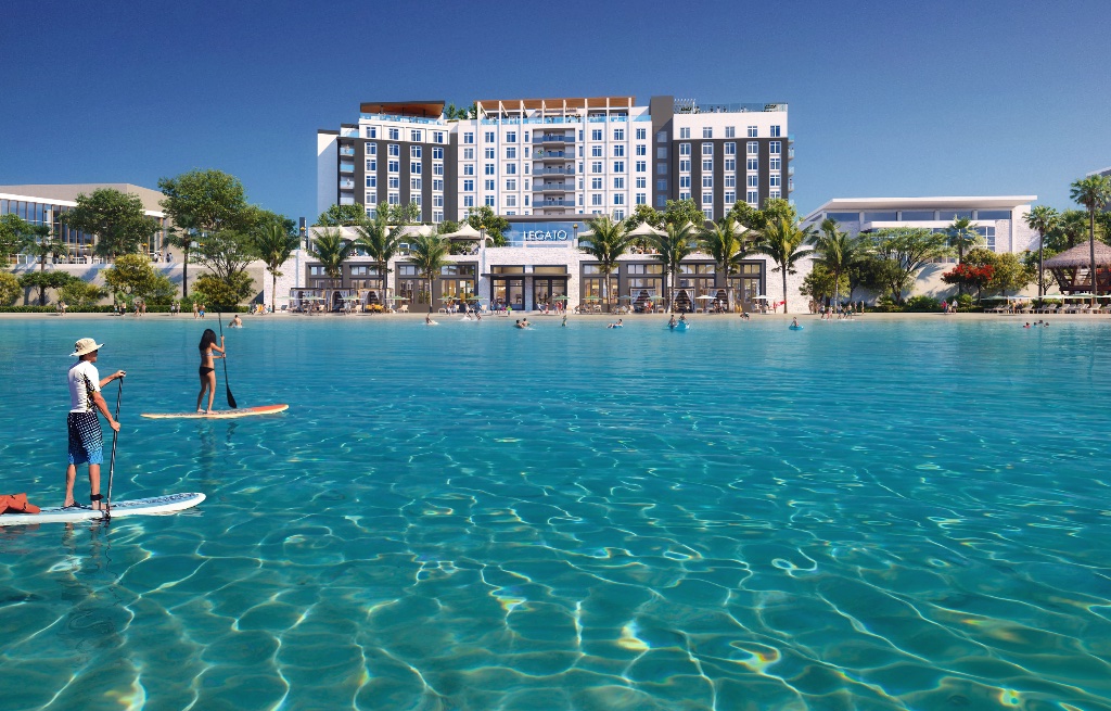 The Legato hotel viewed from the lagoon with paddleboarders