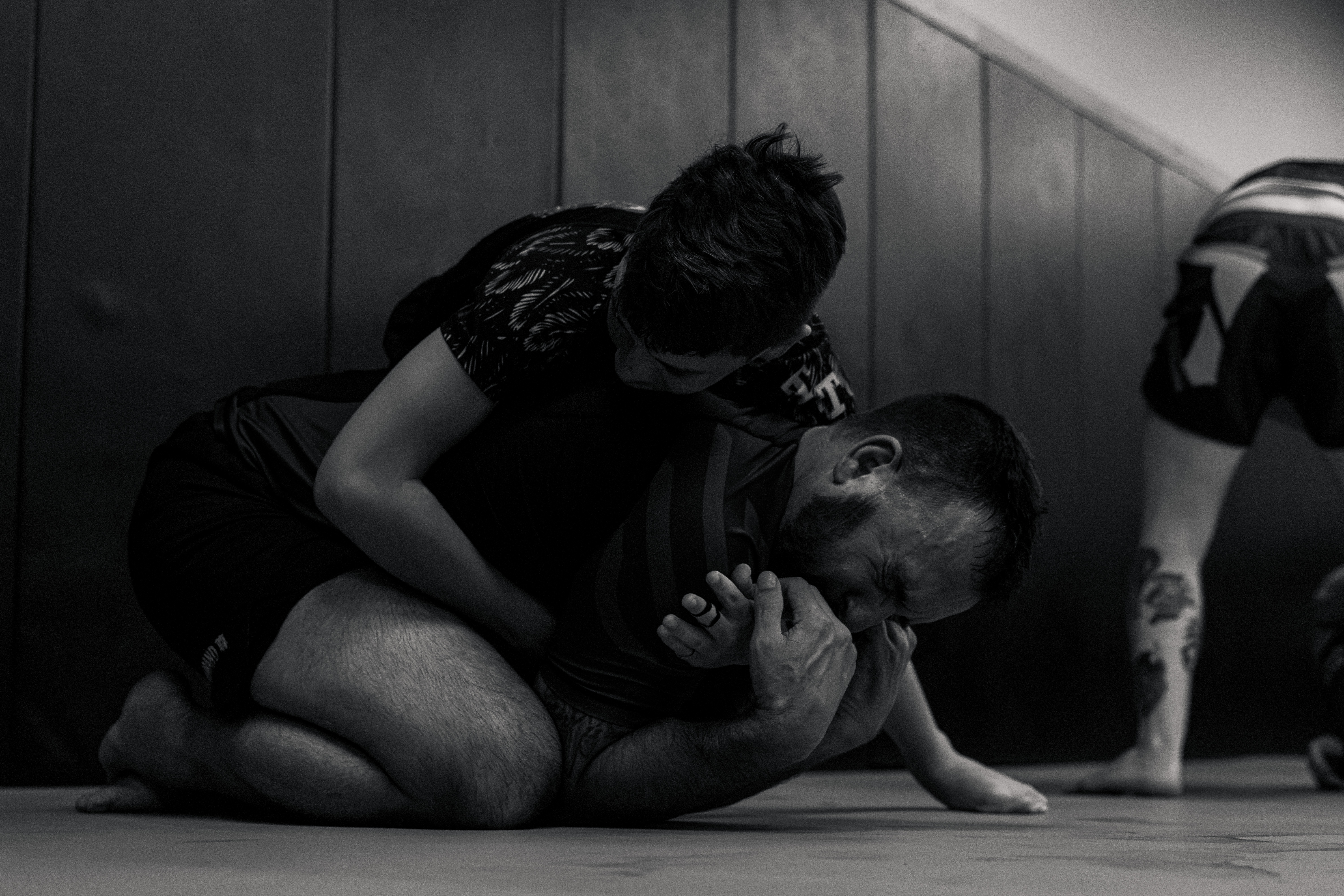 Two grapplers sparring in a close-quarters exchange