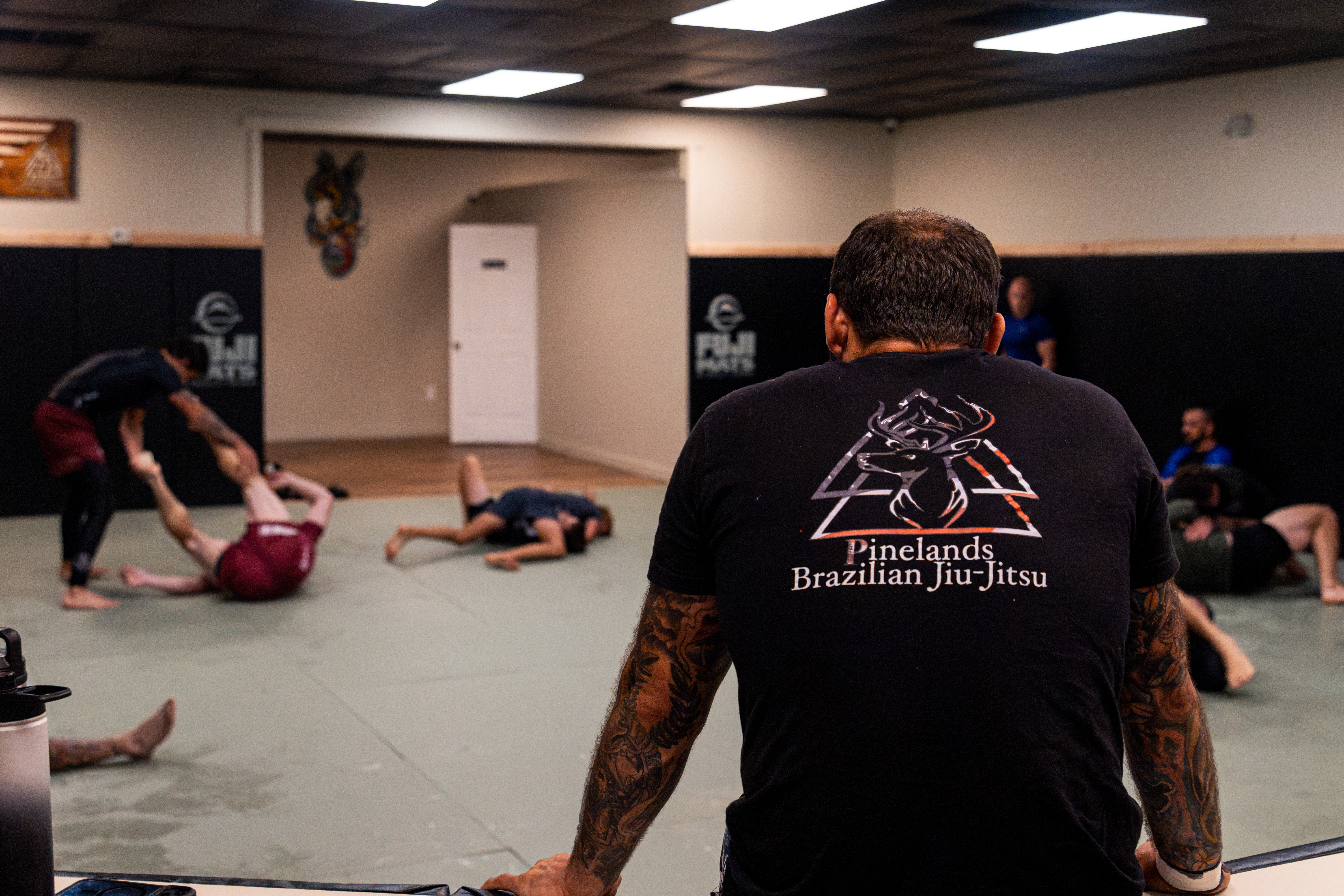 Wide view of the gym floor with students training