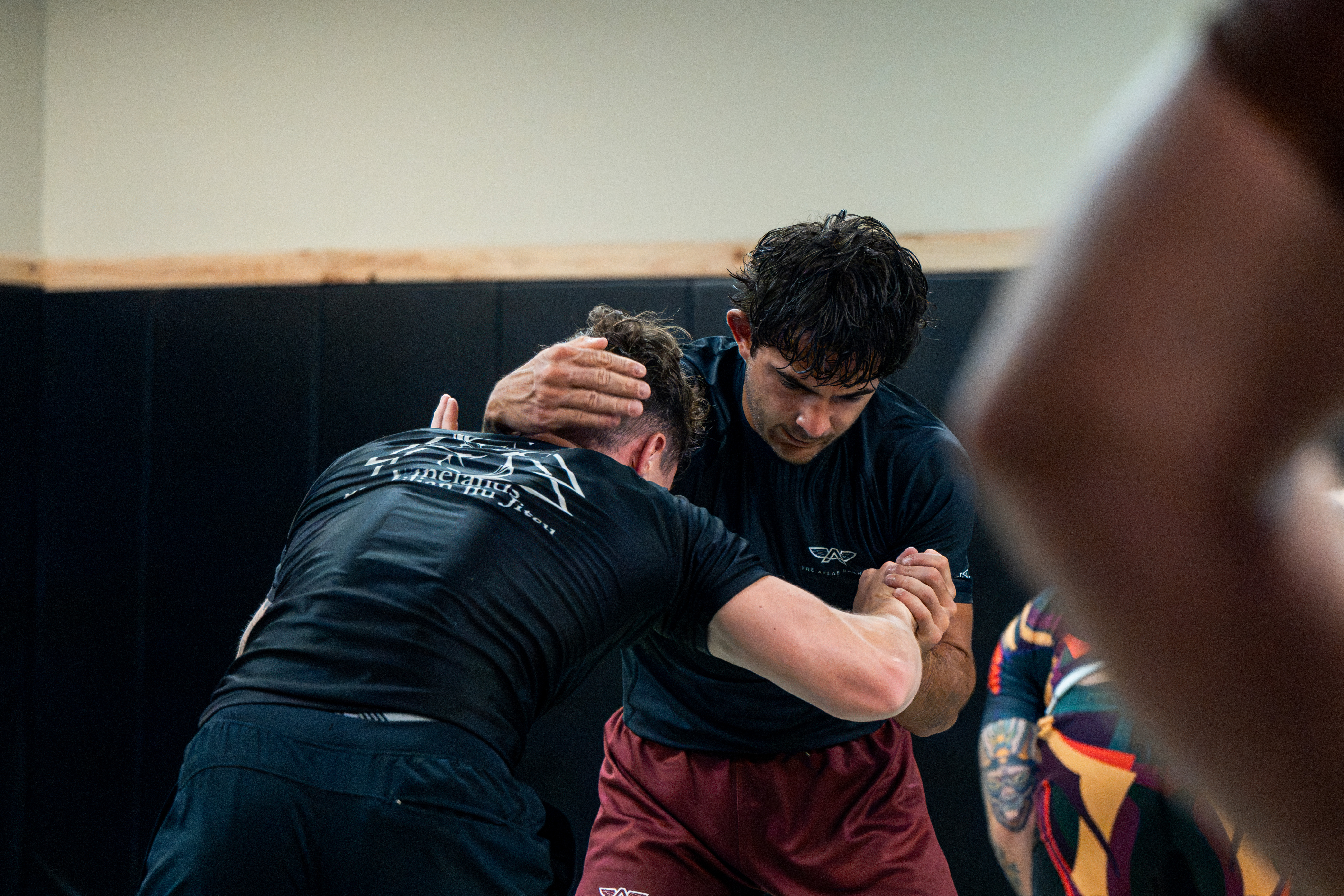 Two grapplers locked in a clinch during training