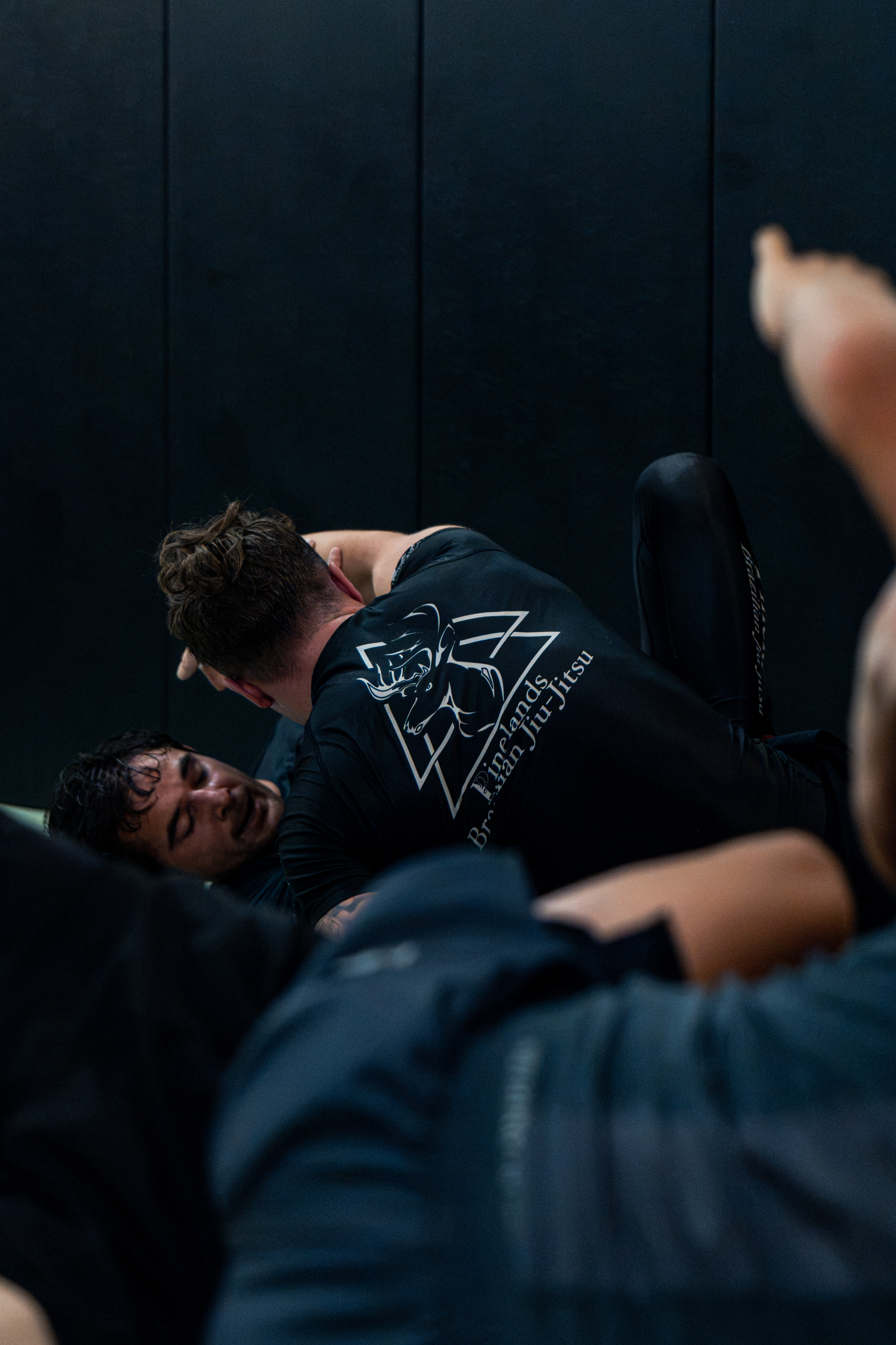 Low-angle shot of a grappler working from the top position