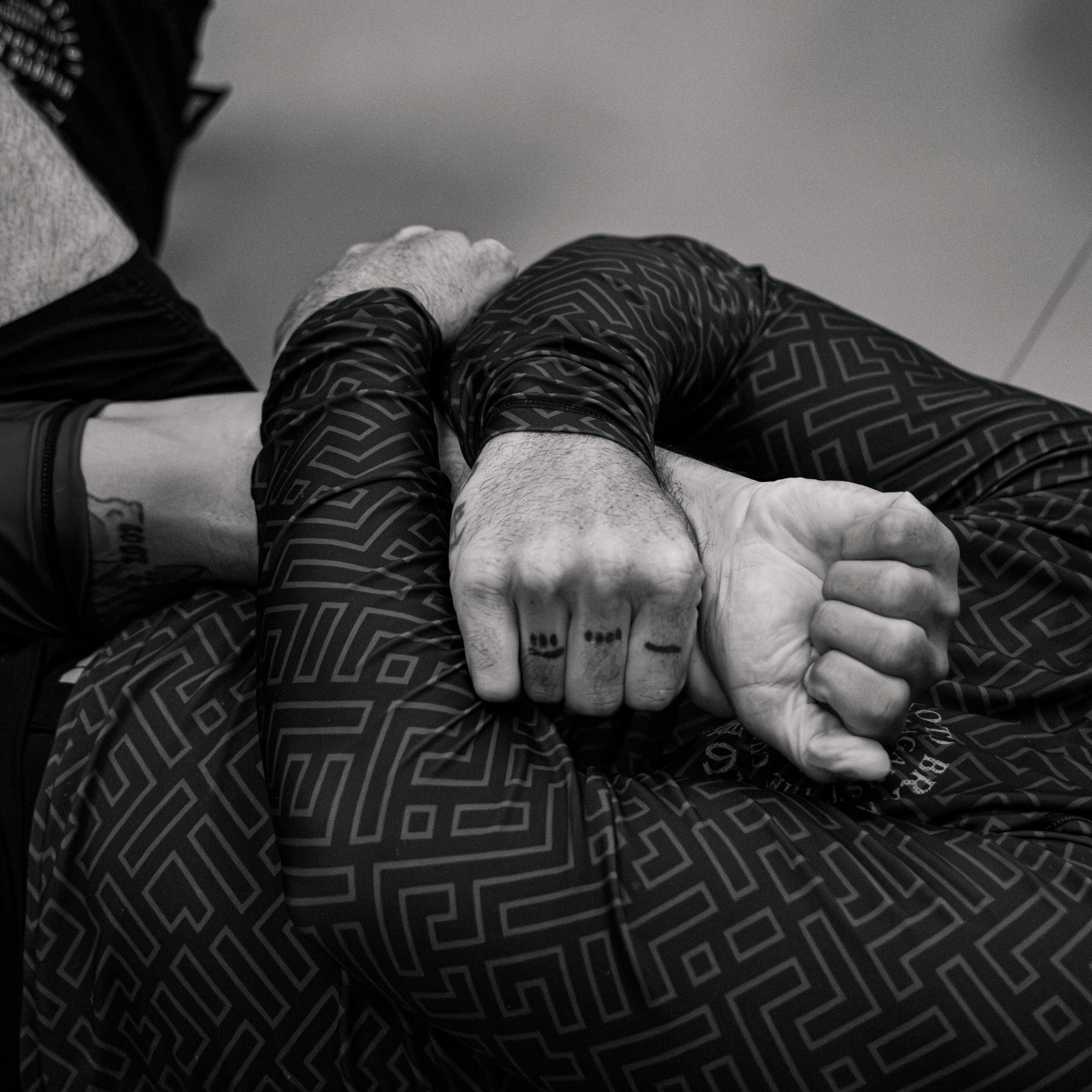 Close-up of gripping hands during a grappling exchange
