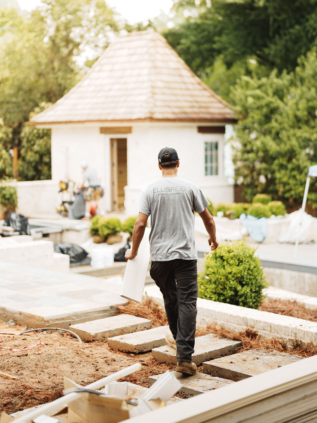 Ellis-Reid team member carrying millwork across a jobsite