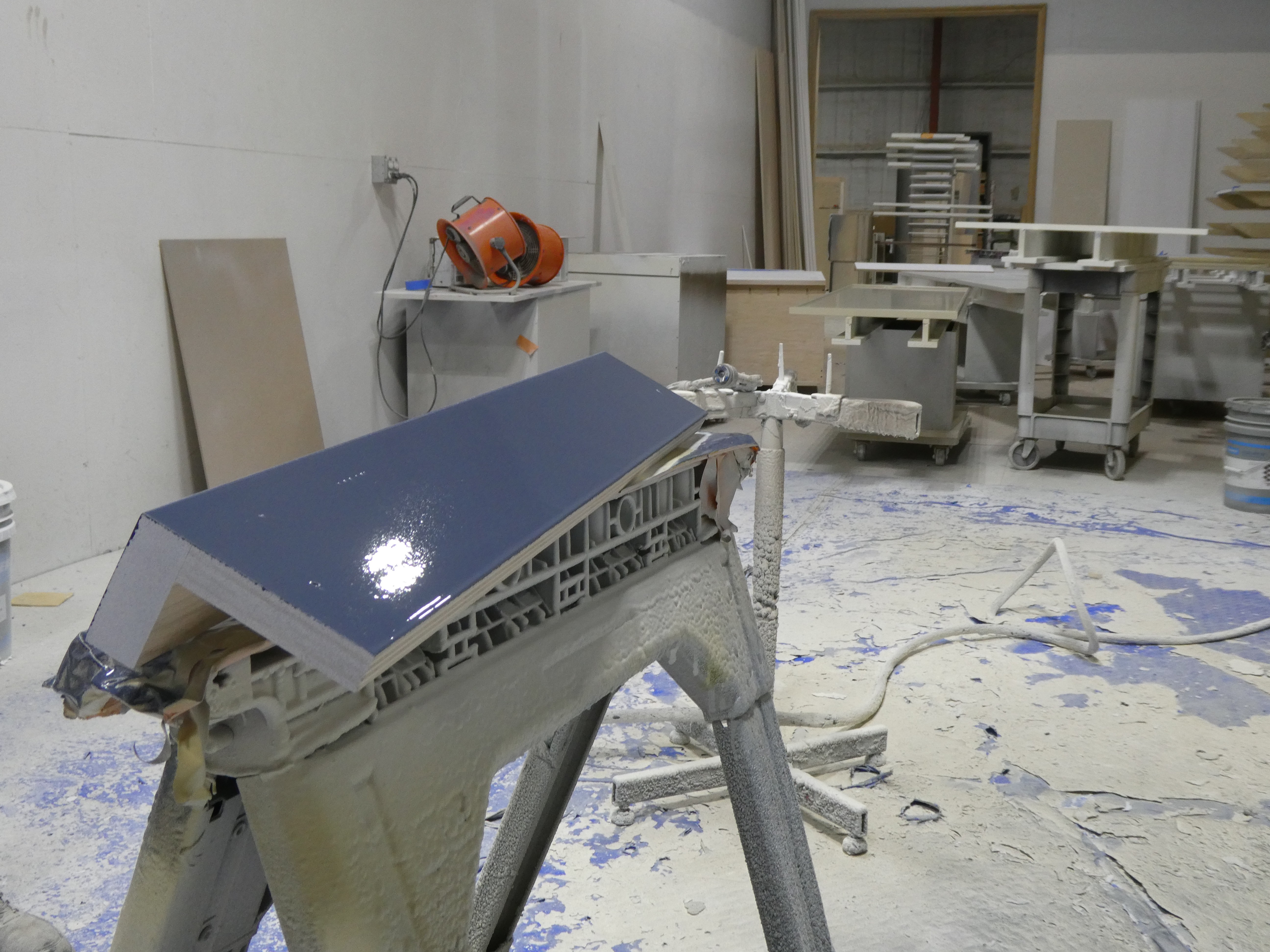 A finished blue crown assembly on the horses in the spray room.