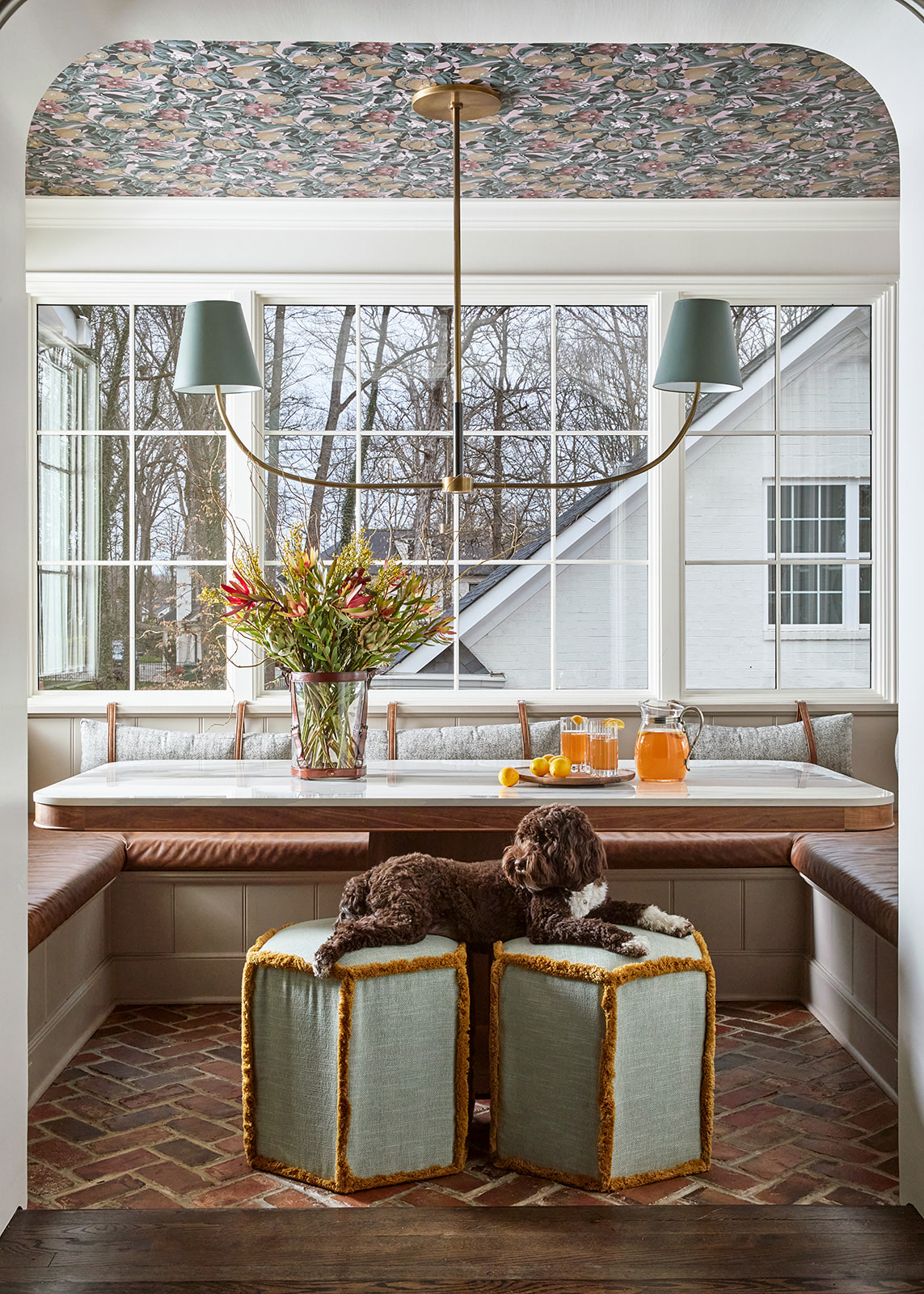 Custom built-in walnut breakfast banquette with integrated wainscot paneling located in a kitchen dining nook.