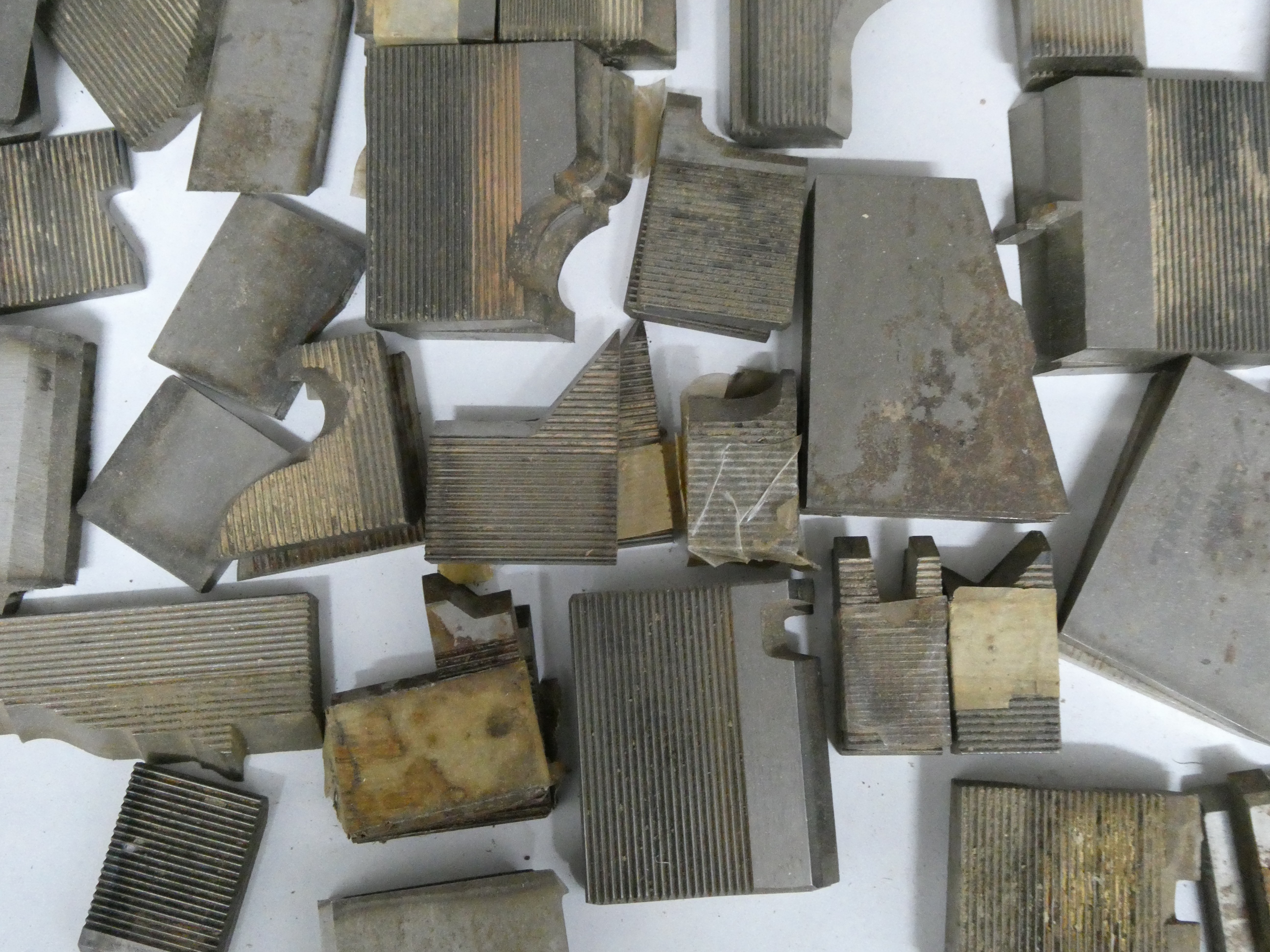 Custom-ground moulder knives laid out, each one matching a drawn Ellis-Reid profile.