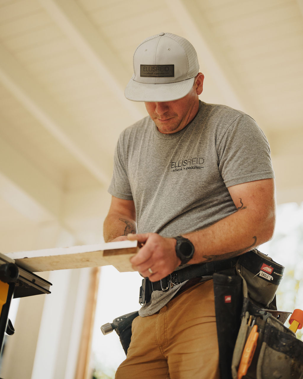 Ellis-Reid craftsman inspecting a piece of millwork stock