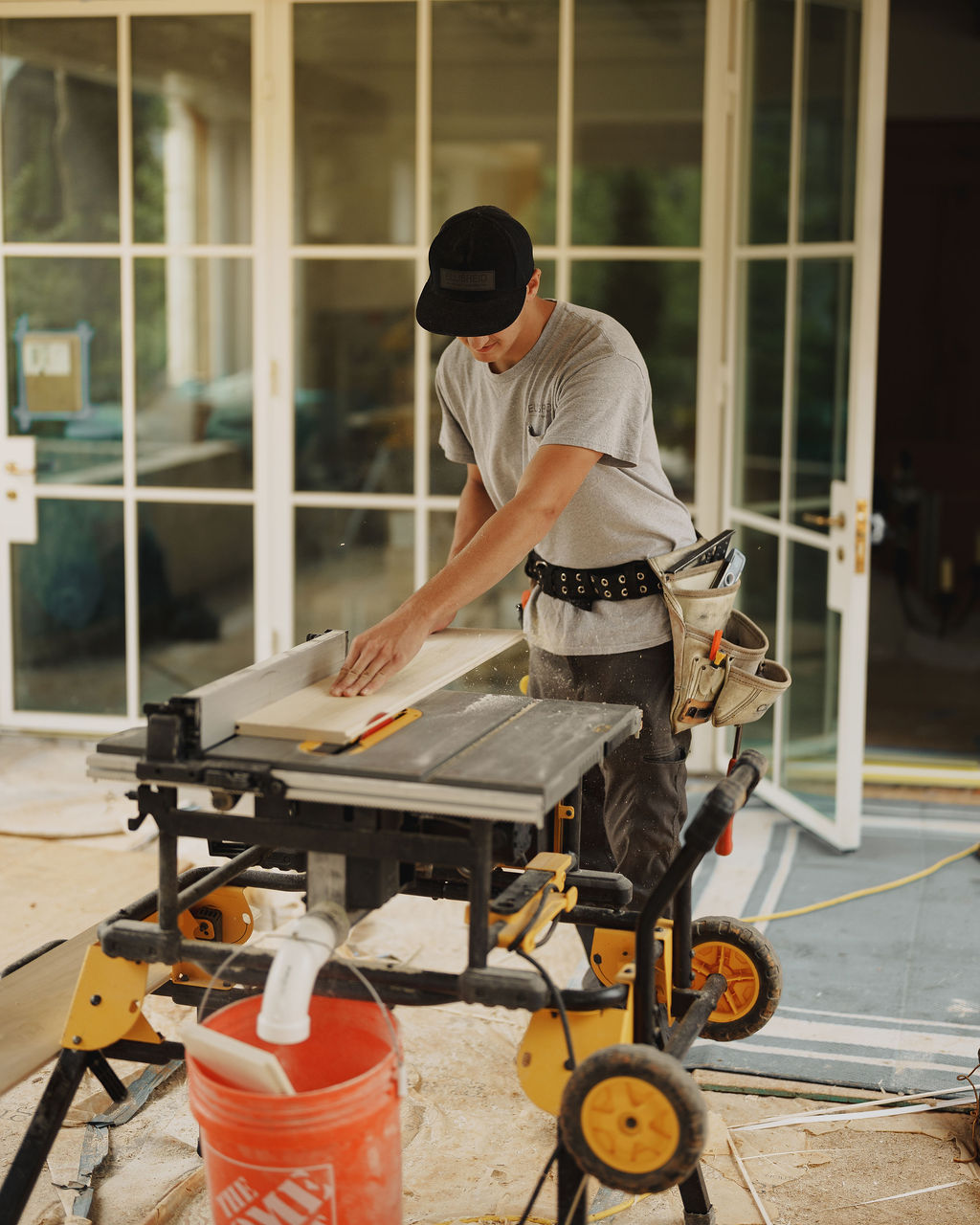Ellis-Reid carpenter marking a length of trim at the miter saw