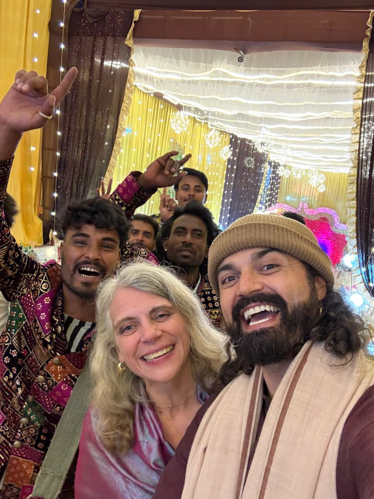BJ and Val celebrating with community — an intentional community built on shared meals, music, and the domestic arts.
