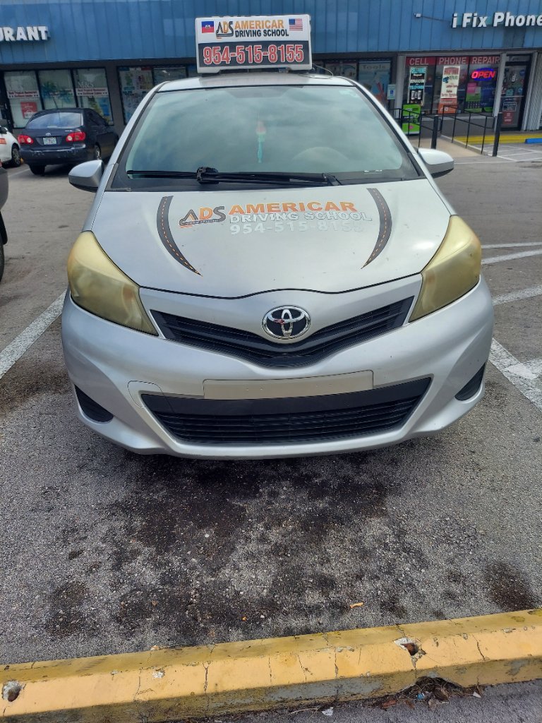 Americar Driving School car rear view showing all courses offered