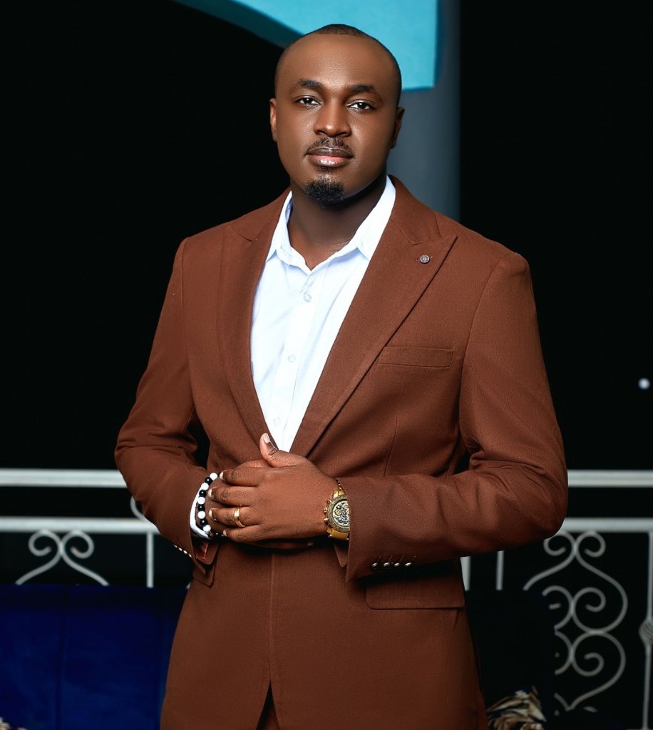 Professional portrait of JD Africa, CEO of Stream Garden, wearing a brown suit jacket over a white dress shirt