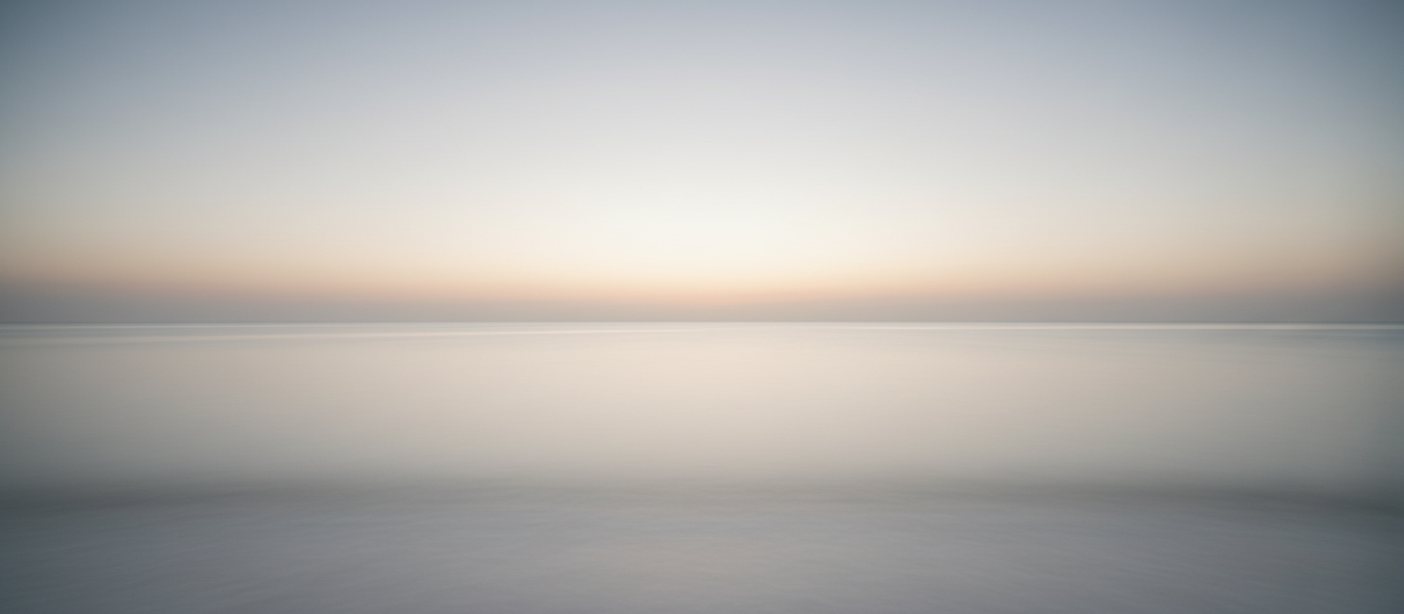 Calm ocean horizon at dawn