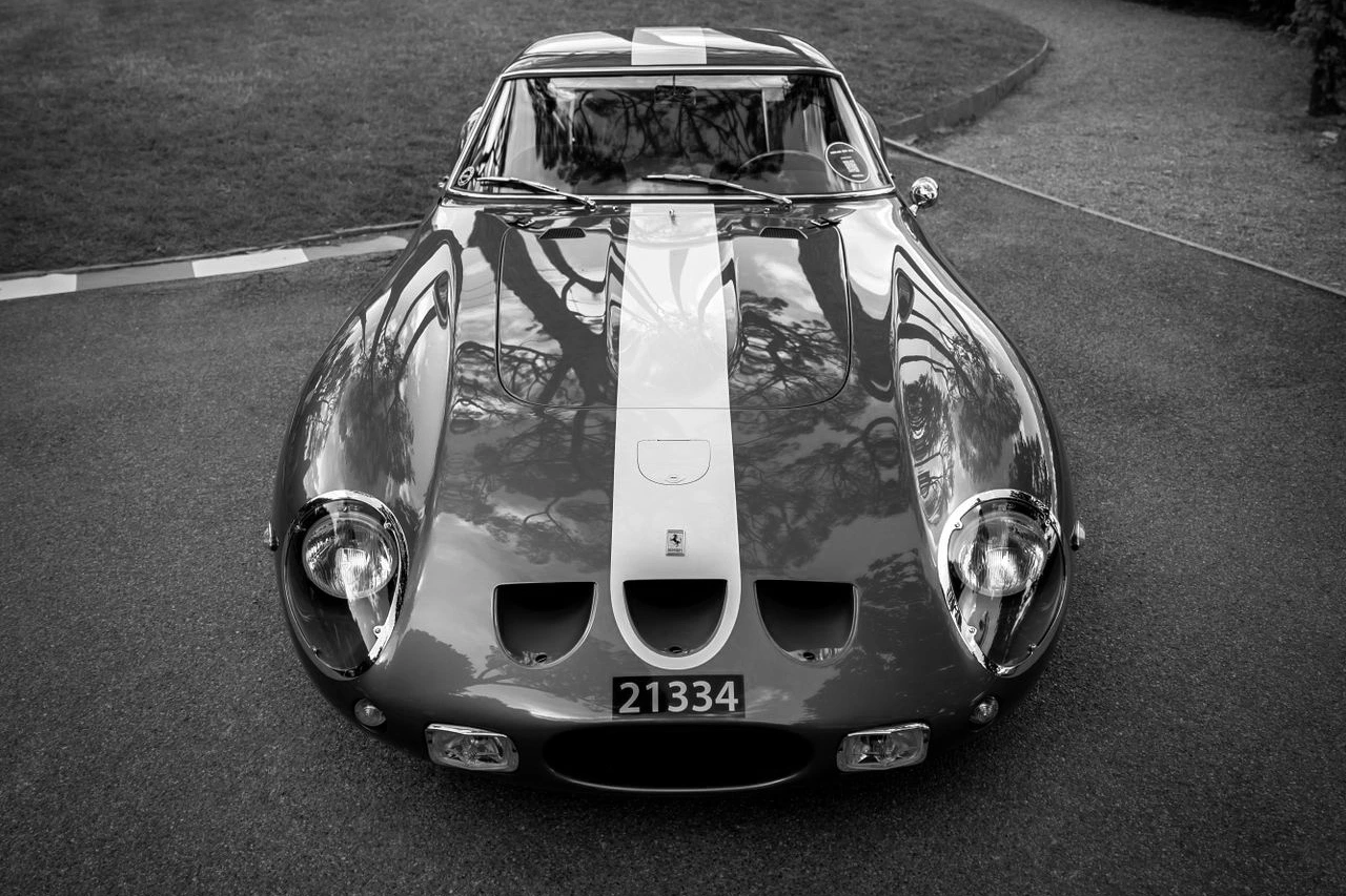 A vintage Ferrari 250 GTO photographed from the front on a driveway