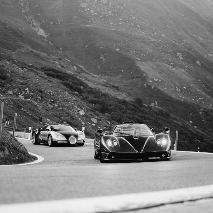 Pagani Zonda and Bugatti Veyron on a mountain road, in black and white