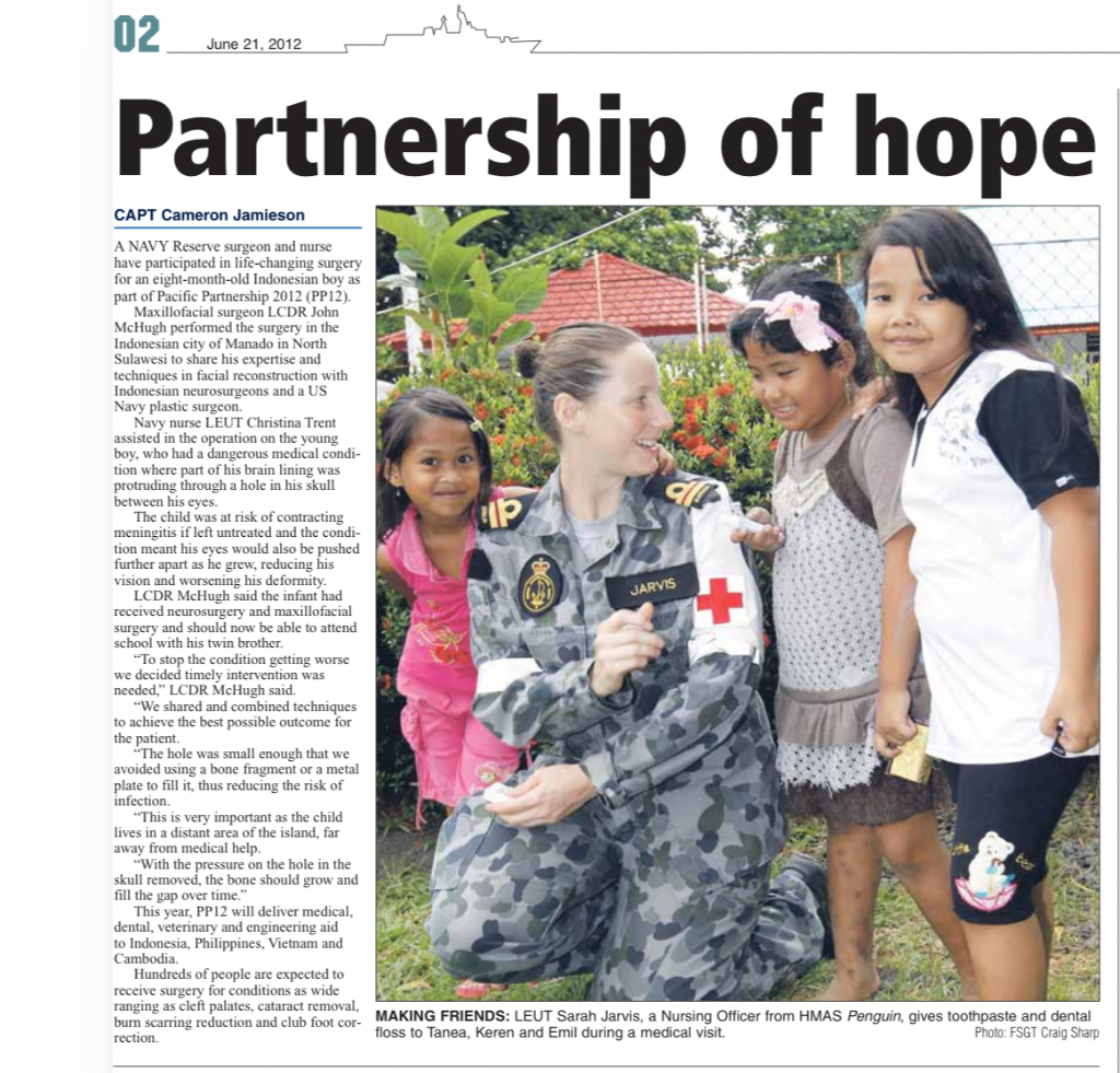 Pacific Partnership 2012 — Navy nurse with Indonesian children during medical visit in Manado, North Sulawesi