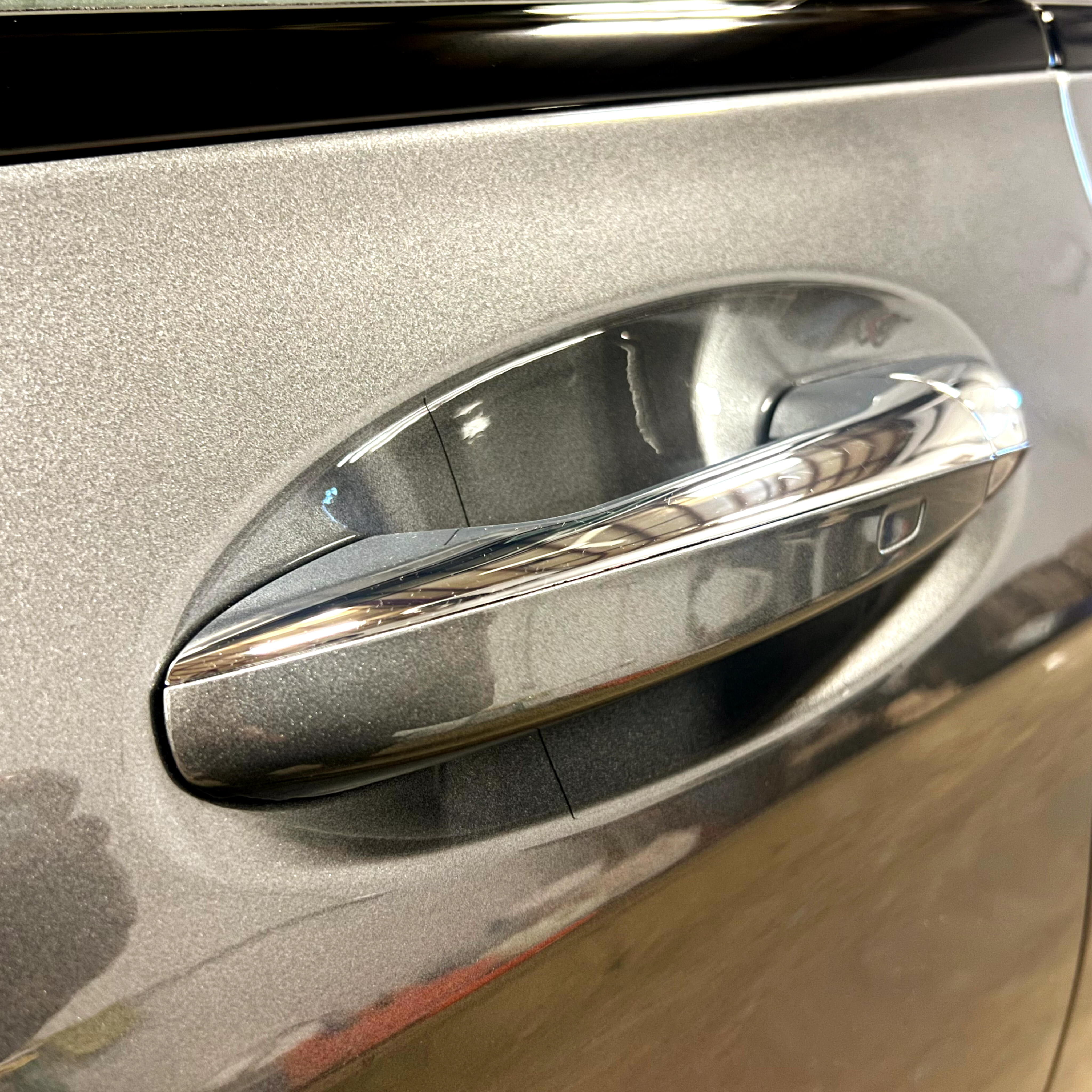 Paint protection film wrapped around a door handle