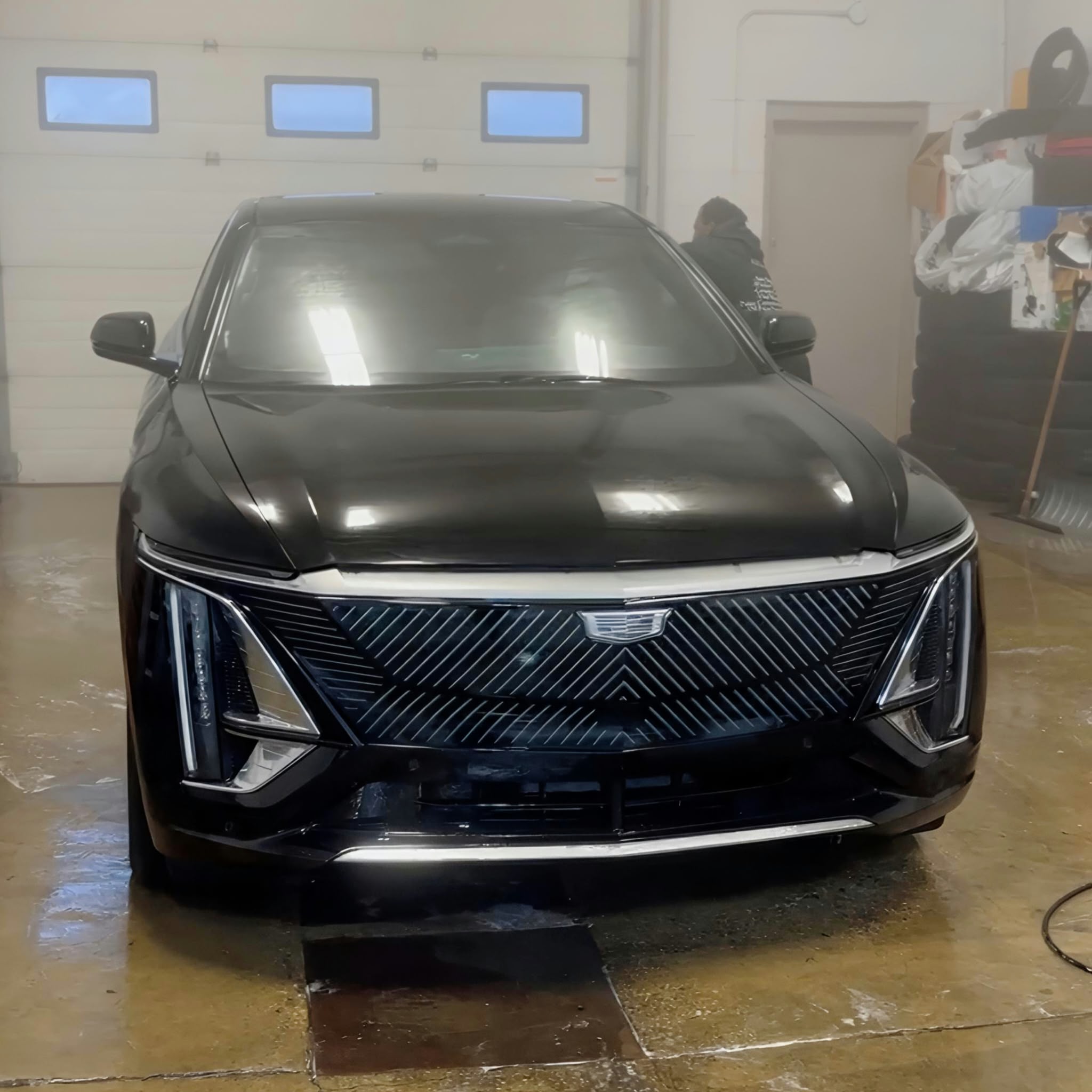 Black Cadillac SUV in the YEG Auto Studio bay being inspected and prepared for paint protection film