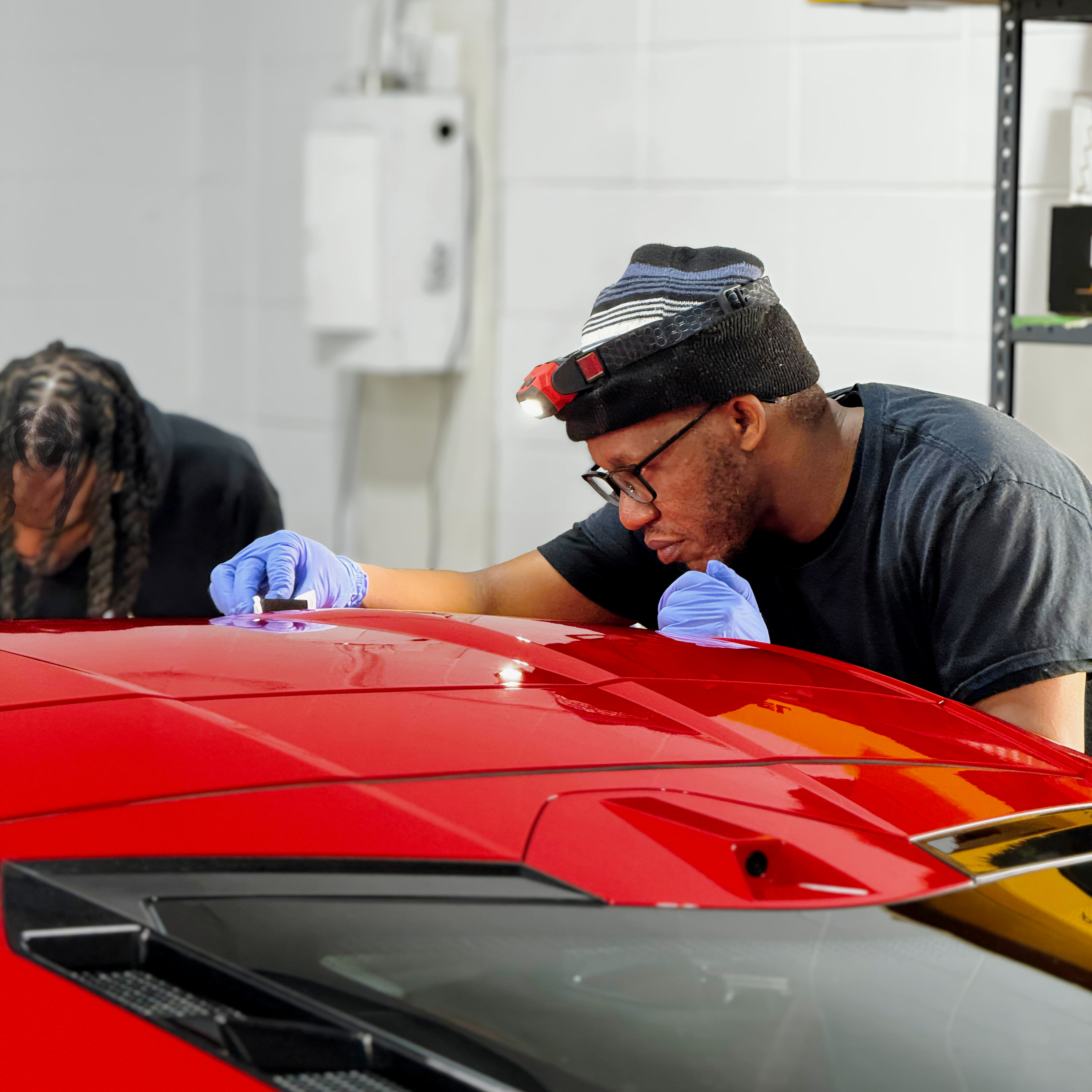 Ceramic coating being applied to a red vehicle at YEG Auto Studio Edmonton