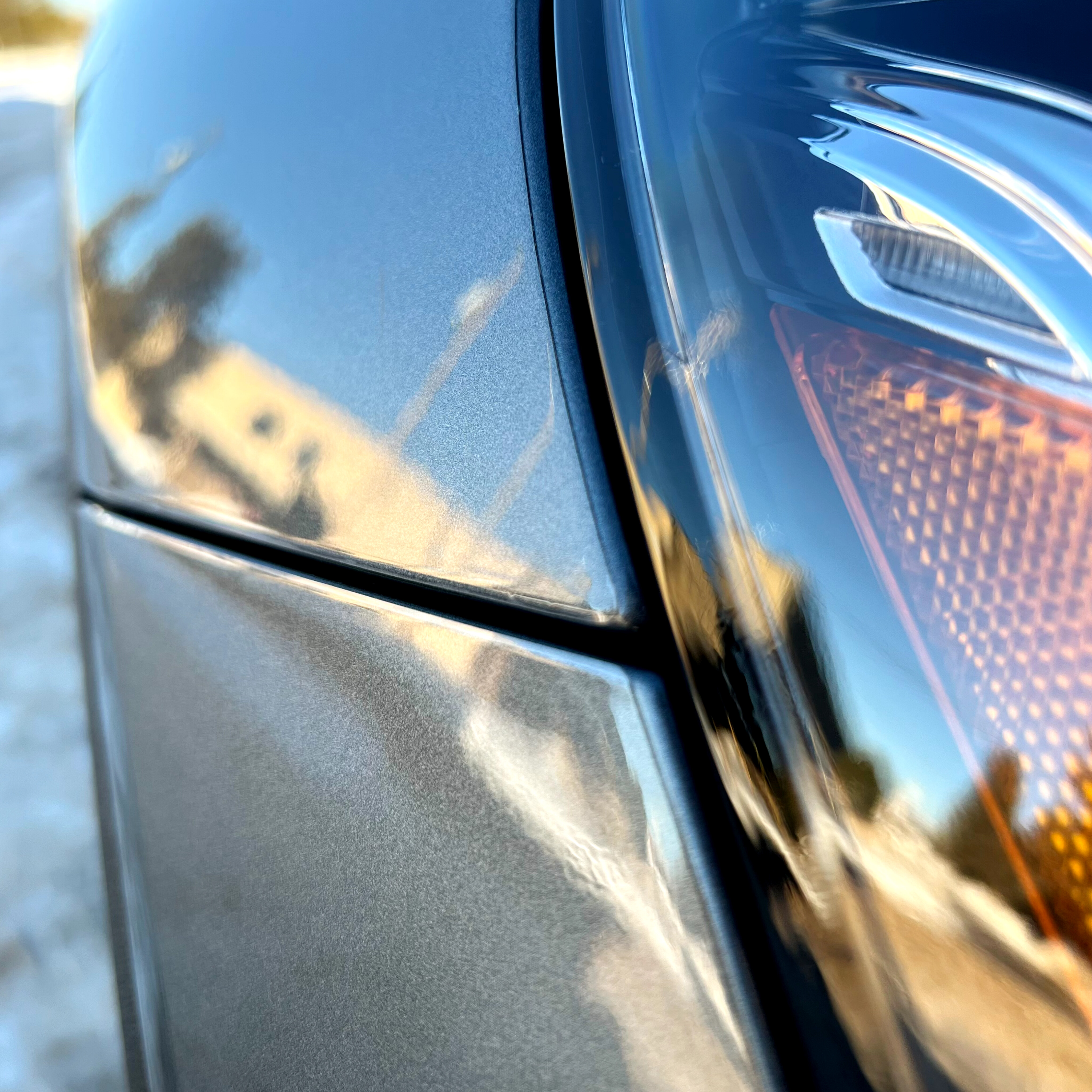 Paint protection film edge detail along a headlight panel