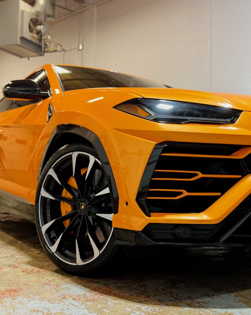 Luxury sports car in professional detailing studio with perfect ceramic coating finish
