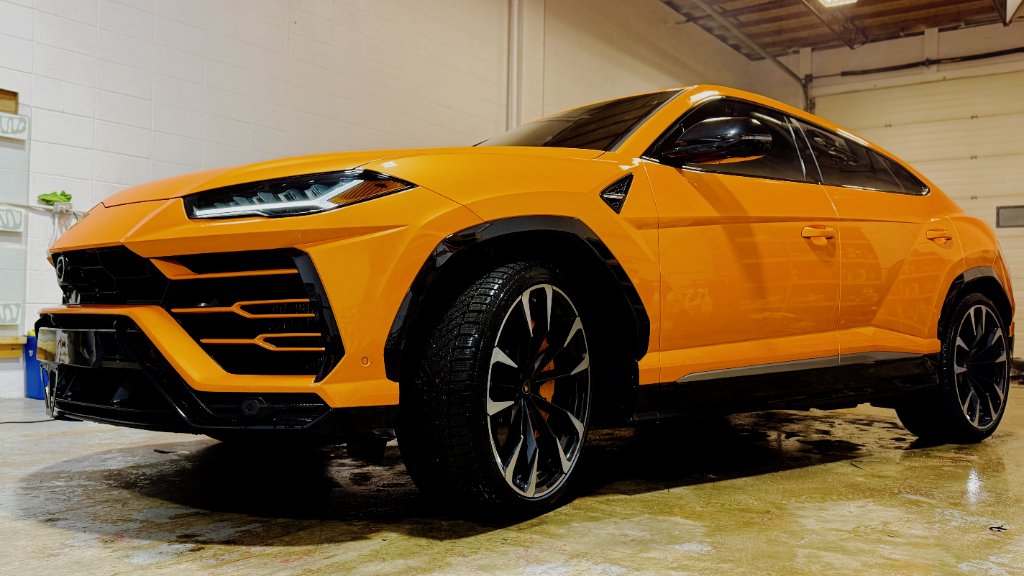 Luxury sports car in professional detailing studio with perfect ceramic coating finish