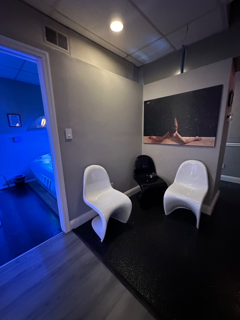 Solar Eclipse Tanning Salon waiting area with neon-lit room