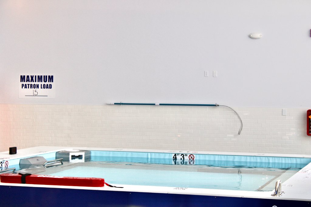 Instructor coaching swimmer in lane