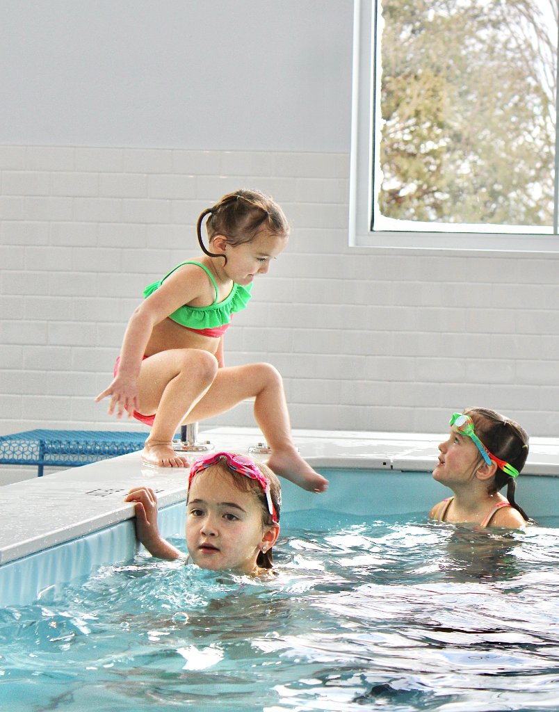 Instructor teaching toddler in pool