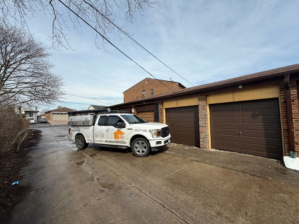 Broken Garage Door Spring Repair — GTA Garage Door service truck at a Toronto home