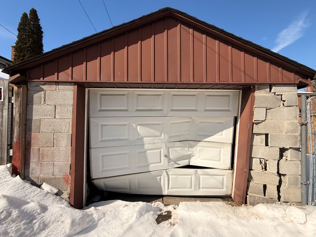 Before — damaged garage door