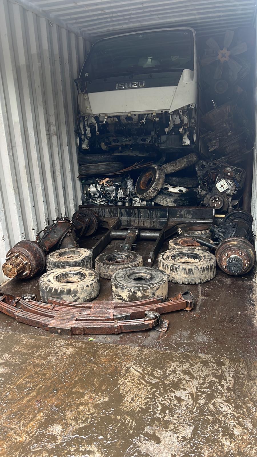 Isuzu Elf + parts — loaded and strapped