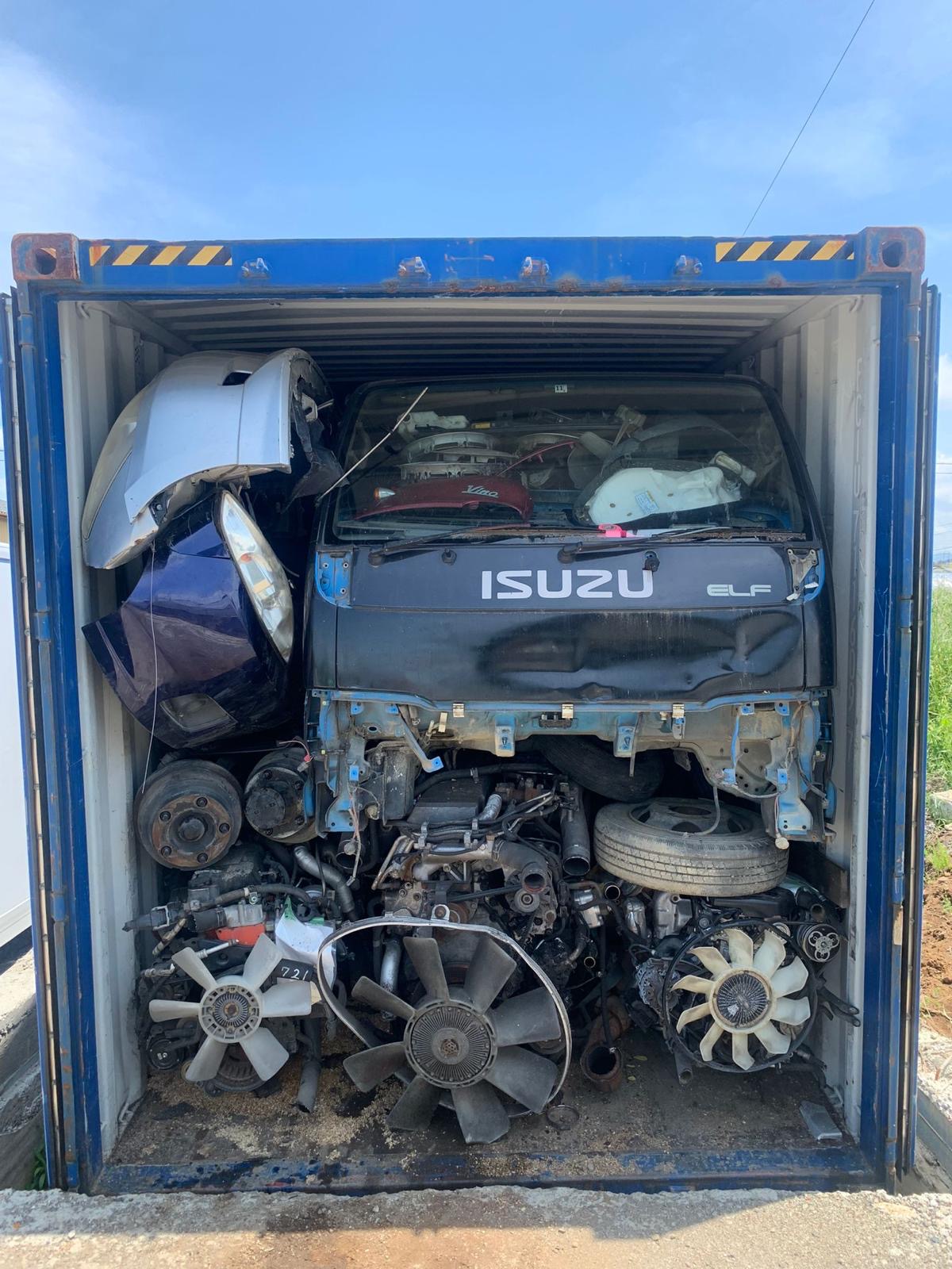 Red truck cab in container — export Japan