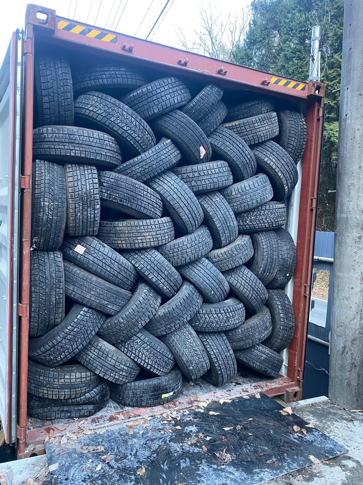 Night loading — team packing tyres into container