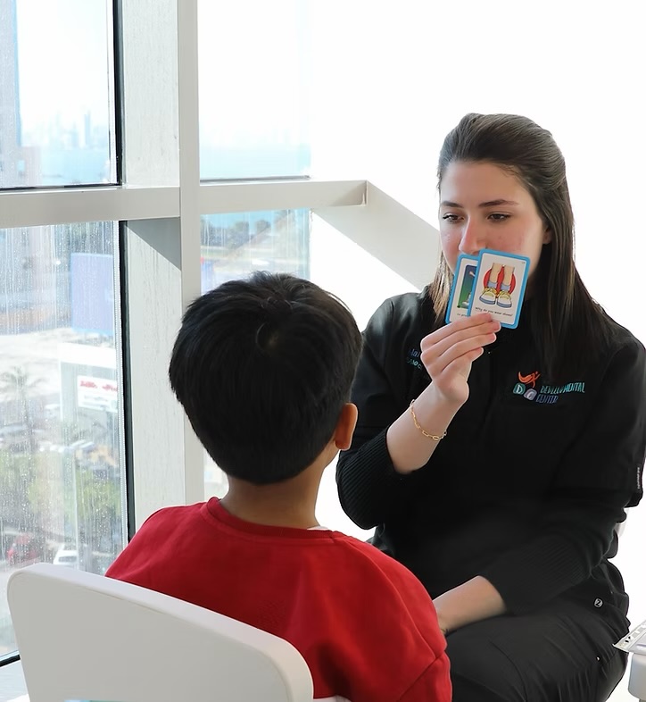 Child's hands building blocks in therapy session
