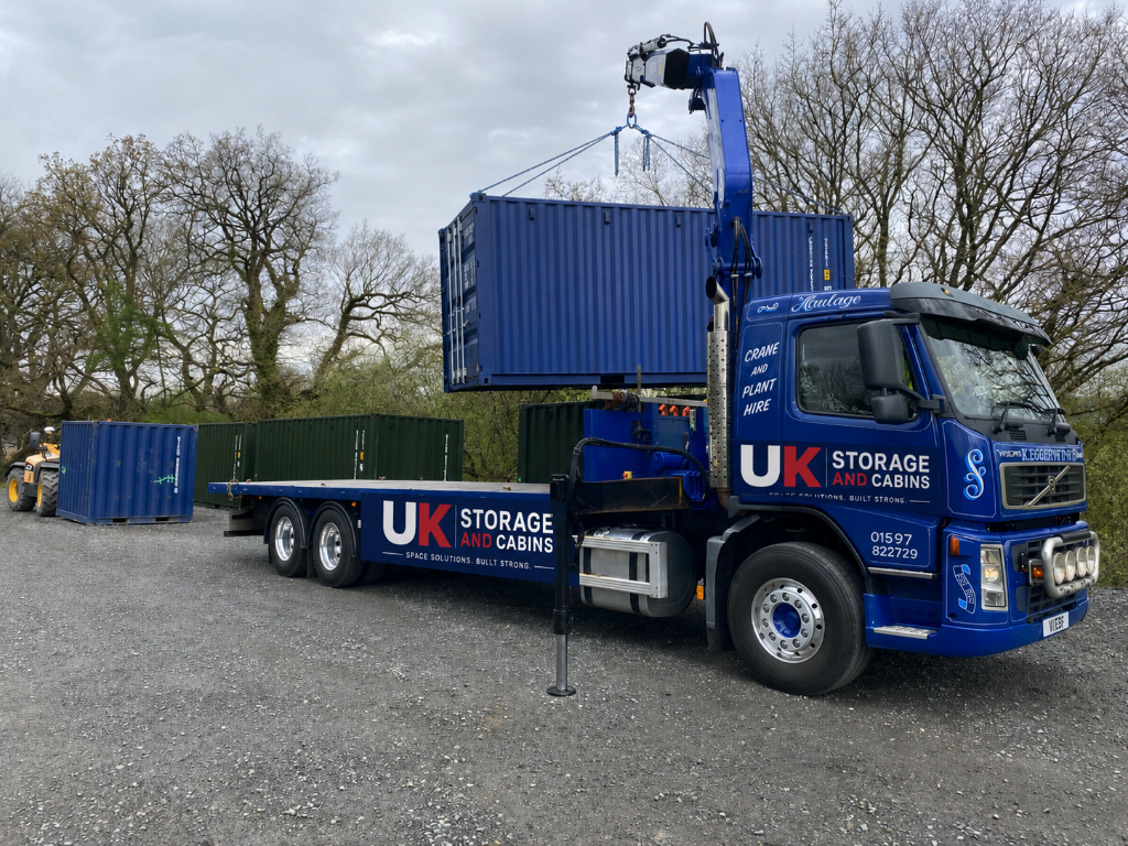 UK Storage and Cabins crane truck delivering a container