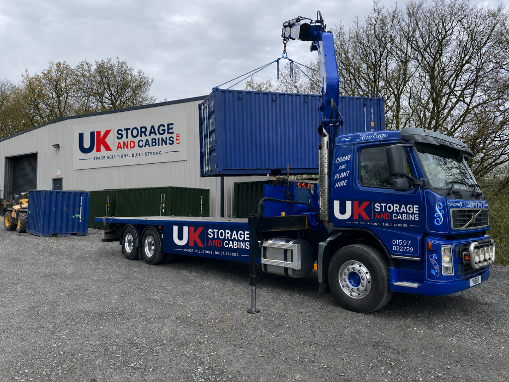 UK Storage and Cabins crane truck delivering a container