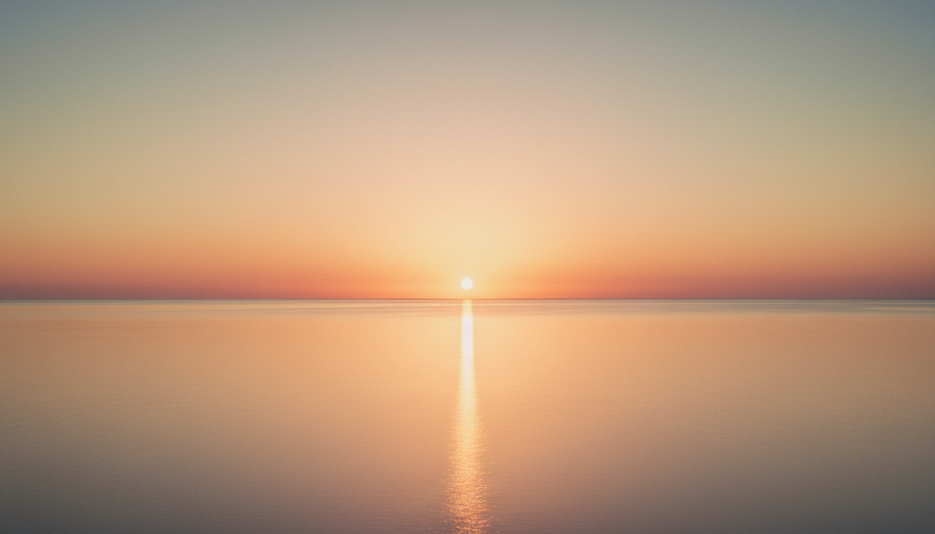 Calm ocean horizon at sunset with warm golden light