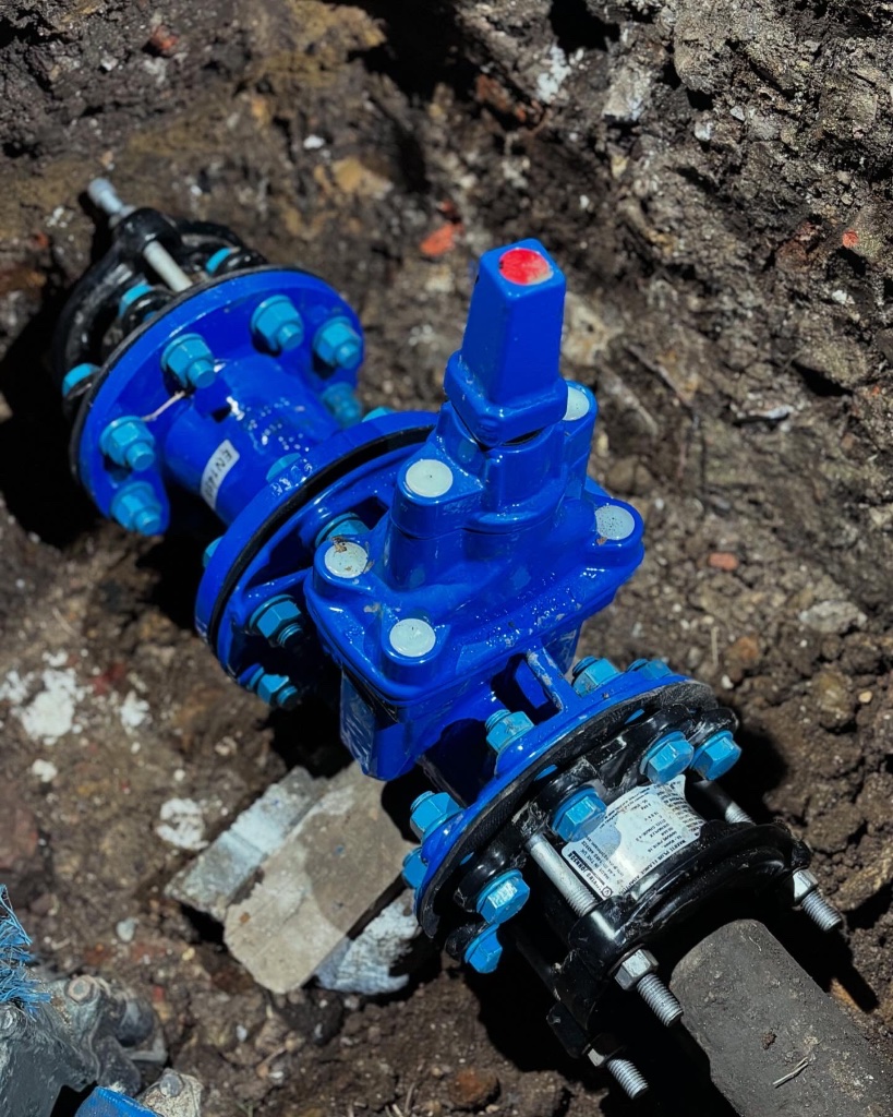 Blue flanged gate valve installed in utility trench with Marti Plus flange coupling by Subsoil Land & Water water utility contractors in Hastings East Sussex