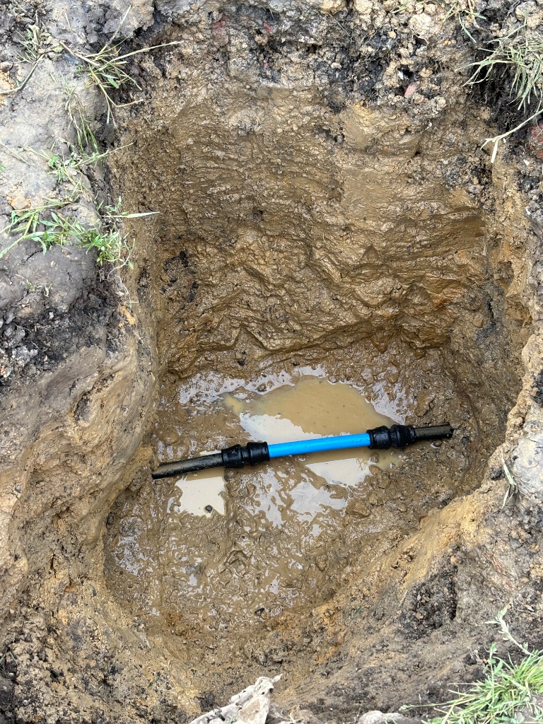 Blue MDPE water pipe installation in underground trench by Subsoil Land & Water, water utility and mains connection contractors in East Sussex