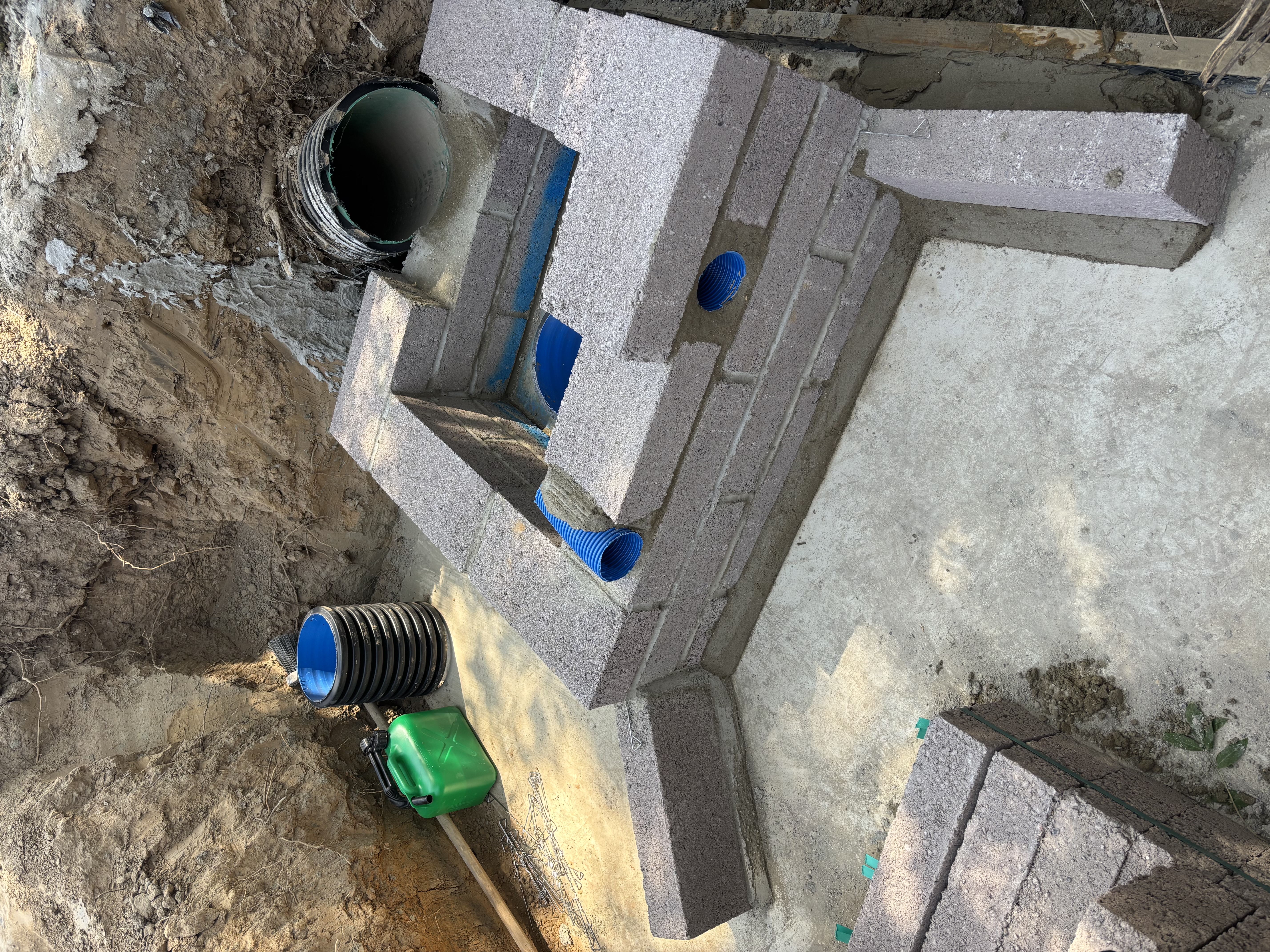 Concrete blockwork chamber with corrugated drainage pipes integrated into block walls on a concrete pad base — blockwork and concreting in Sussex by Subsoil Land & Water, concrete works contractors in Battle, East Sussex