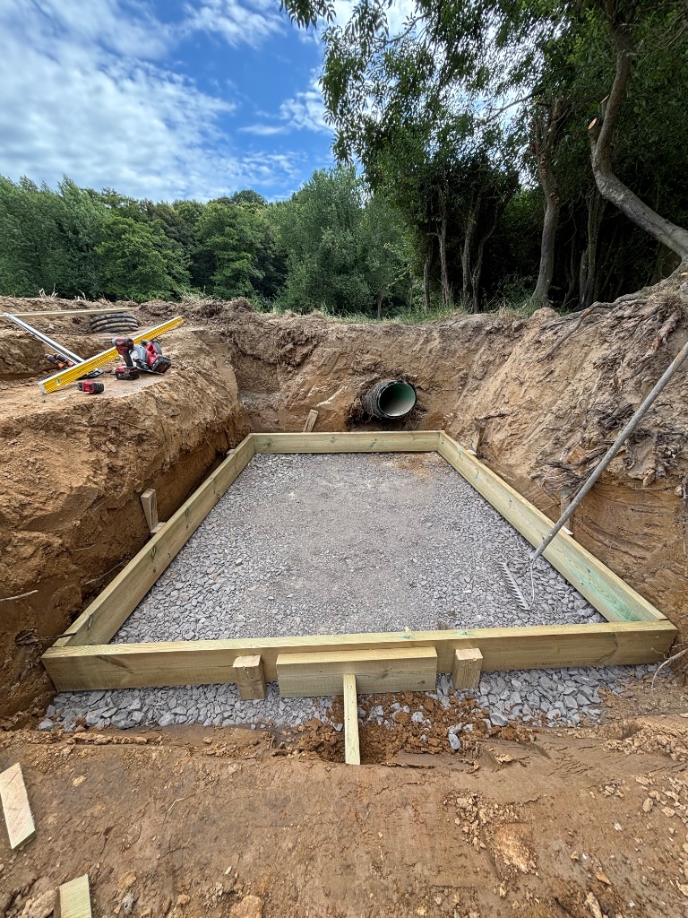 Timber-formed soakaway and drainage pipe installation during earthworks and site clearance in Battle, East Sussex by Subsoil Land & Water groundworks contractors